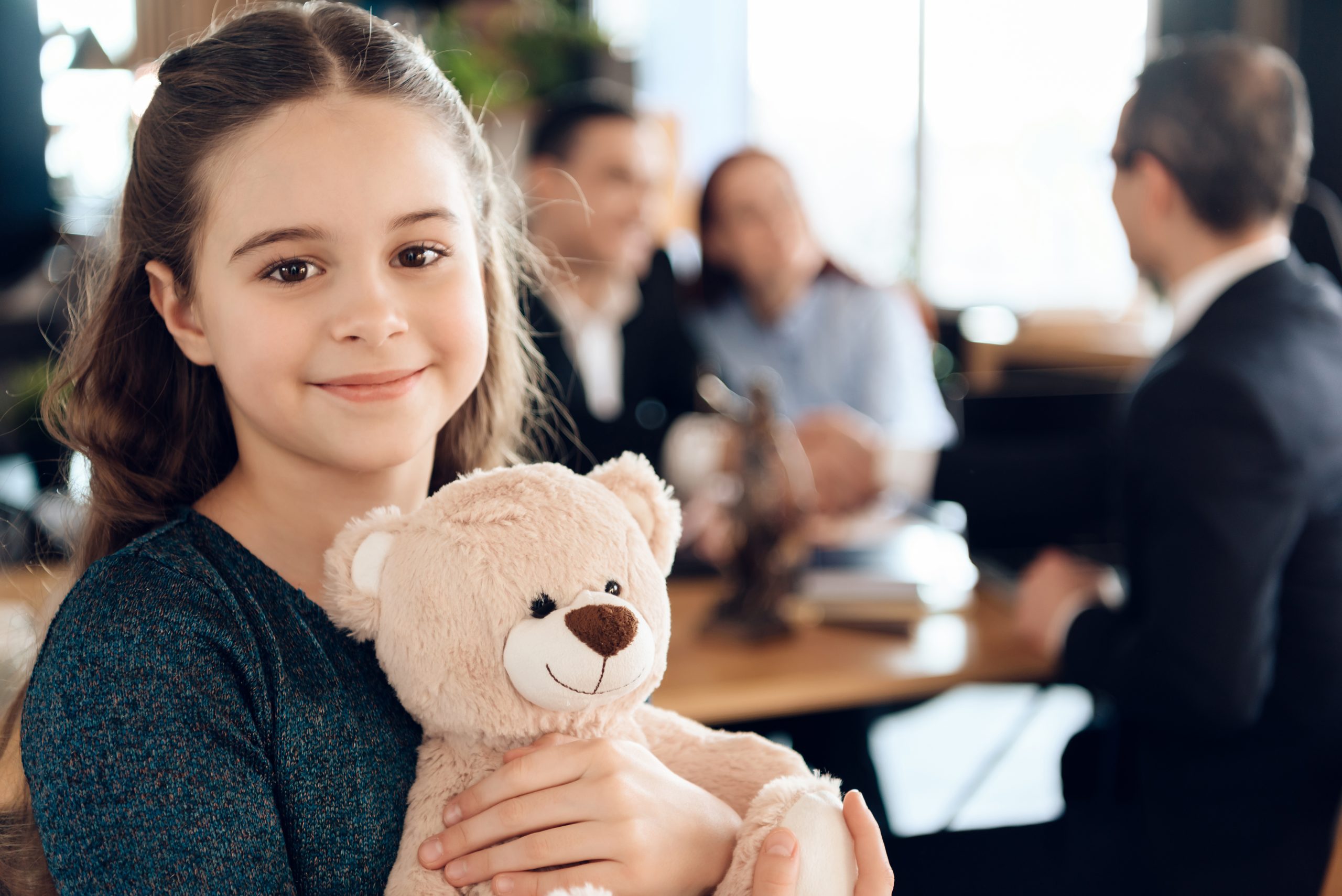 little child hugging a teddy bear